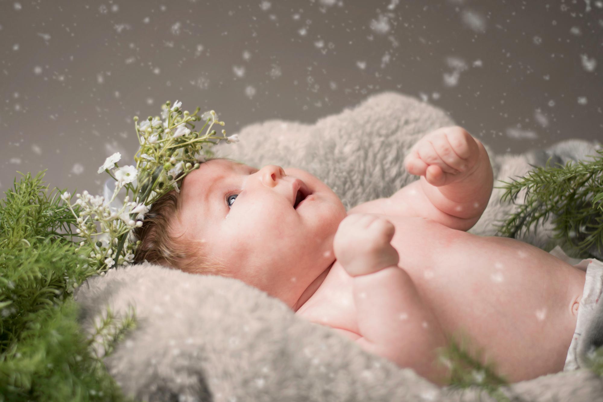 Baby looking up in wonder at new snowfall